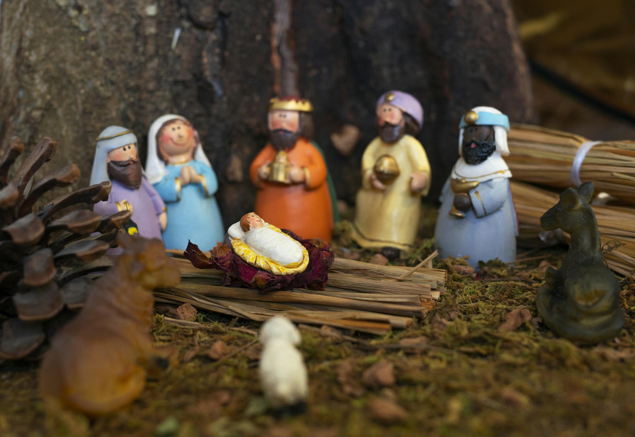 Clay nativity scene depicting baby Jesus, Virgin Mary, and Three Wise Men with figurines and animals.